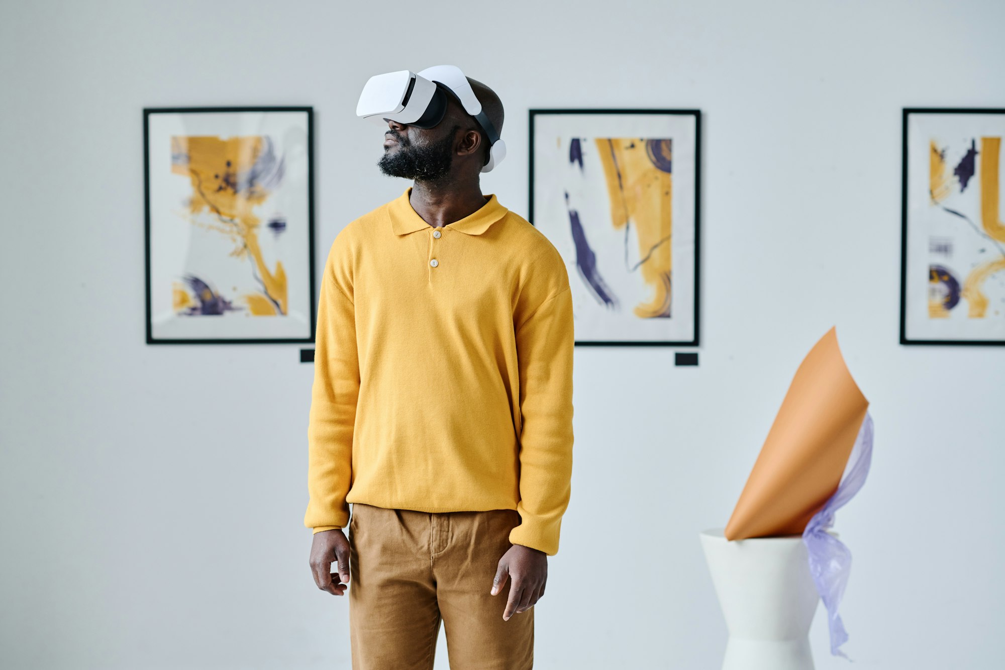 Man in virtual reality glasses at gallery